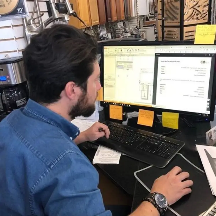 Omer from Home Art Tile Kitchen & Bath in Queens, NY using KitchenDEV at his desk in the showroom